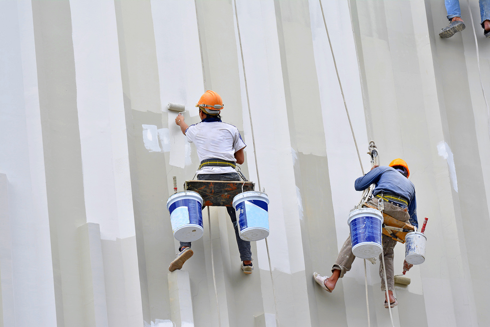 Asian,Painters,Are,Hanging,To,Paint,With,High,Building